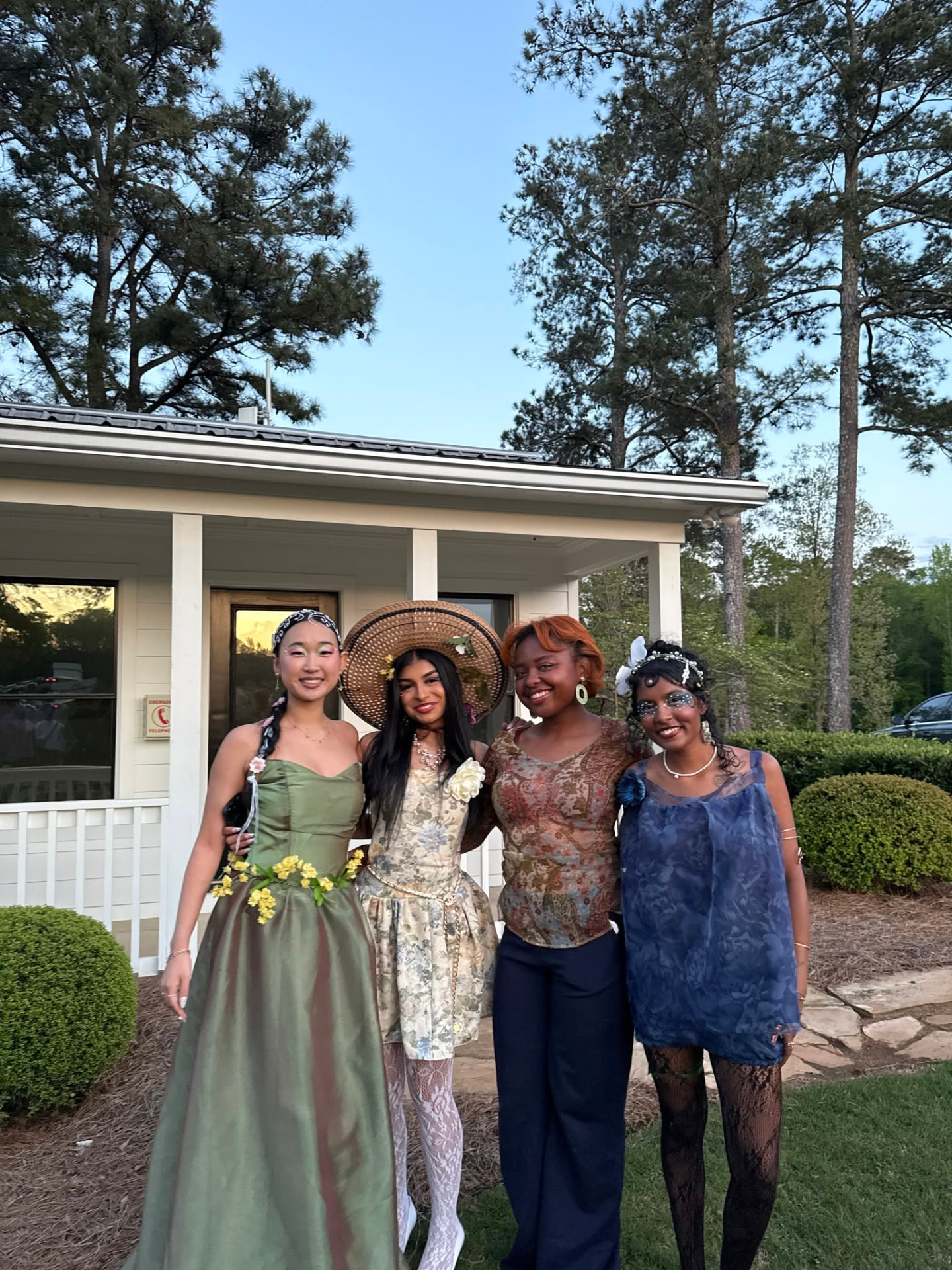 Four models wearing Raine Cox's FDSA Spring 2025 designs outdoors